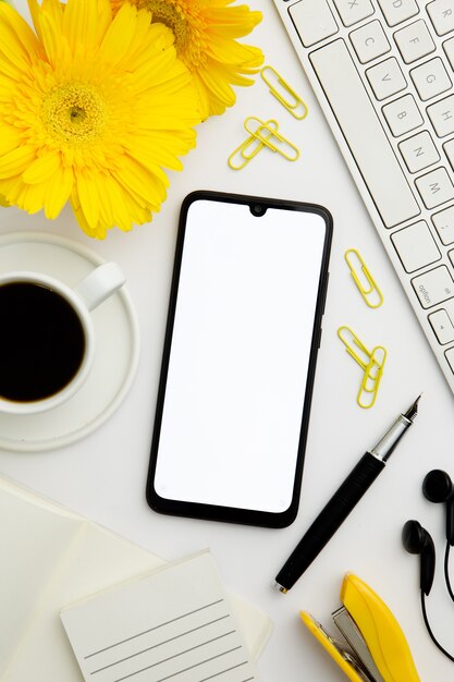 Top view supplies arrangement on desk with phone