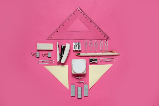 Top view supplies composition on pink background