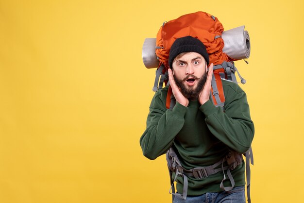 Top view of surprised travelling guy with packpack