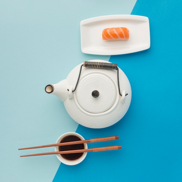 Top view sushi day concept with teapot