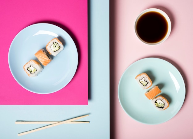 Top view  sushi plates with chopsticks and soy sauce