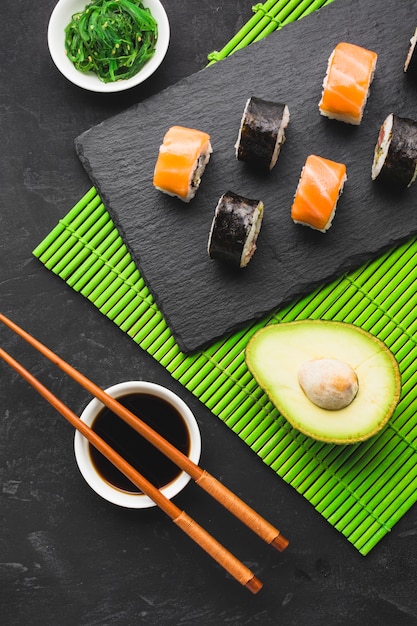 Free photo top view sushi plating on bamboo mat