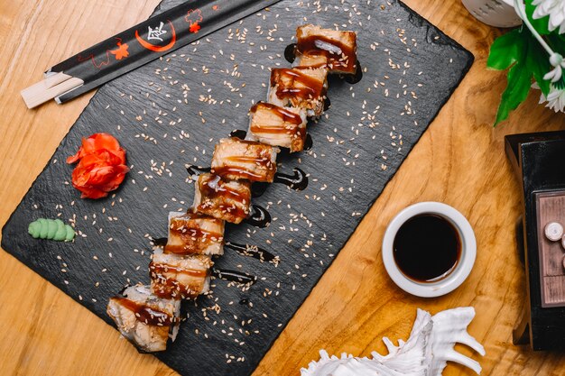 Top view sushi rolls with eel with ginger wasabi and soy sauce