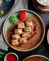 Free photo top view of sushi rolls with salmon pickled ginger slices and wasabi on a plate on rustic