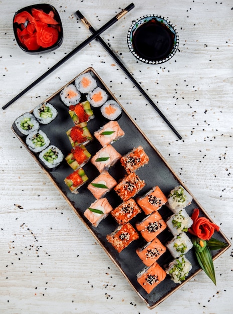 Top view of sushi set served with wasabi, ginger, and soy sauce