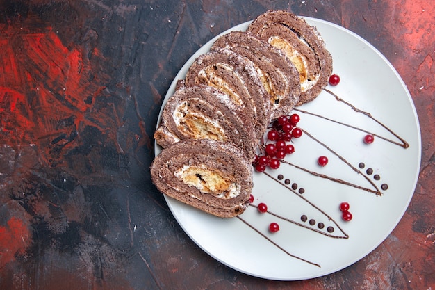 Top view of sweet biscuit rolls sliced creamy cakes