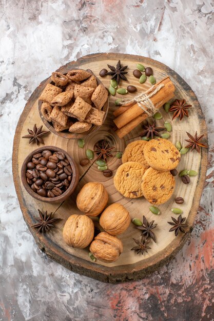 Free photo top view sweet biscuits with coffee and walnuts on light table