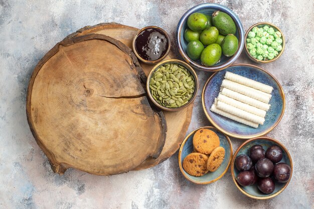 top view sweet biscuits with fruits on a light background photo tea dessert