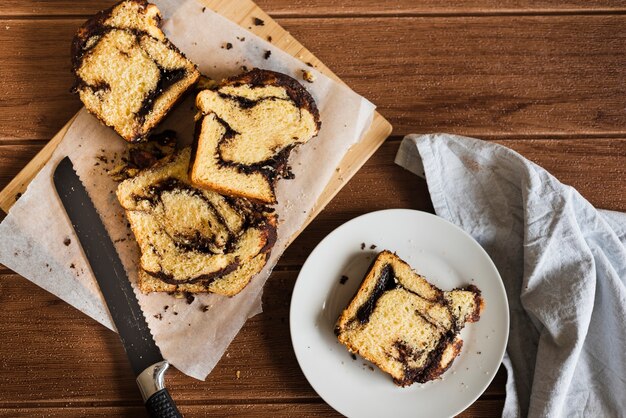 Top view of sweet bread slices on wooden table