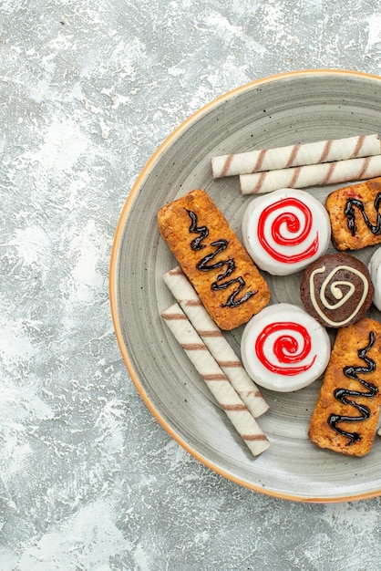 Top view sweet cookies and cakes on light-white background cake biscuit tea sugar cookie sweet