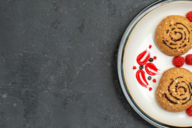 Top view sweet cookies delicious sweets for tea on dark grey background cookie sugar sweet biscuit cake