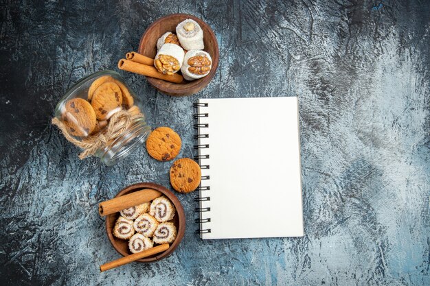 Top view of sweet cookies inside can on dark surface