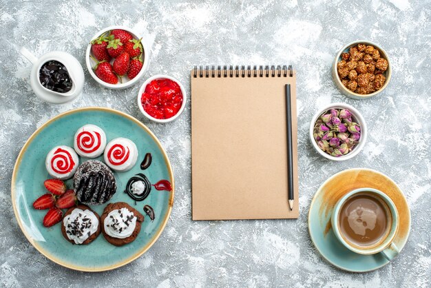 Top view sweet delicious biscuits with cup of coffee on white background biscuit sugar cake cookie sweet