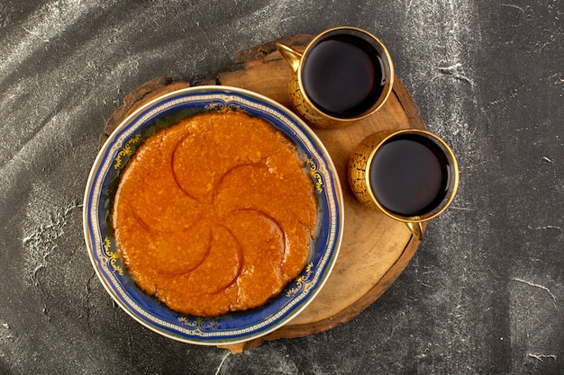 A top view sweet delicious halva yummy eastern sweet dessert inside plate with tea