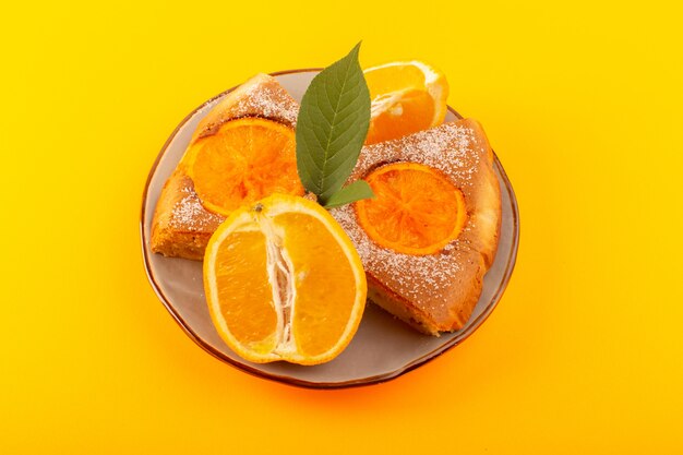 A top view sweet orange cake sweet delicious slices of cake along with sliced orange inside round plate on the yellow background biscuit sweet sugar