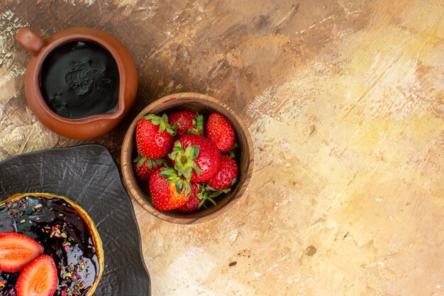 Top view sweet pancakes with fruits on a wooden desk