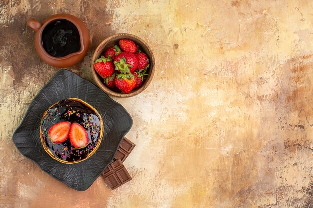 Top view sweet pancakes with fruits on wooden desk