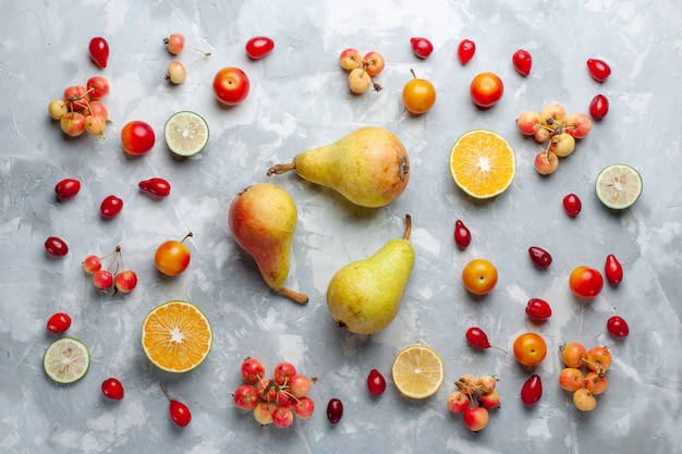 Top view sweet pears with lemon and cherries on white desk