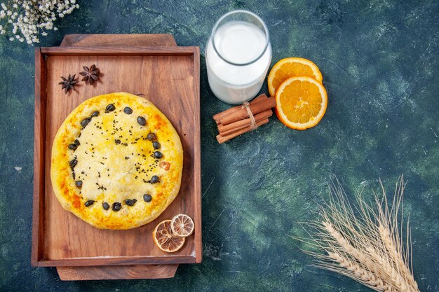 Top view sweet pie inside wooden desk on dark blue background pie cake bake dessert cookie fruit hotcake