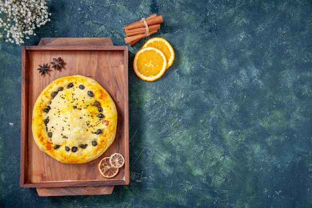 Top view sweet pie inside wooden desk on dark blue background pie cake bake dessert pastry cookie fruit hotcake free space