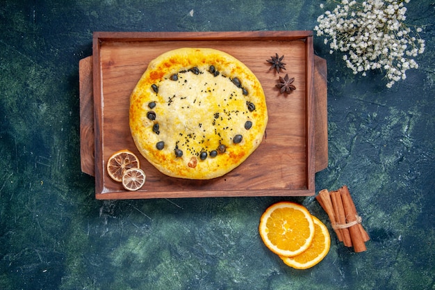 Top view sweet pie inside wooden desk on dark blue background pie cake bake dessert pastry cookie fruit hotcakes