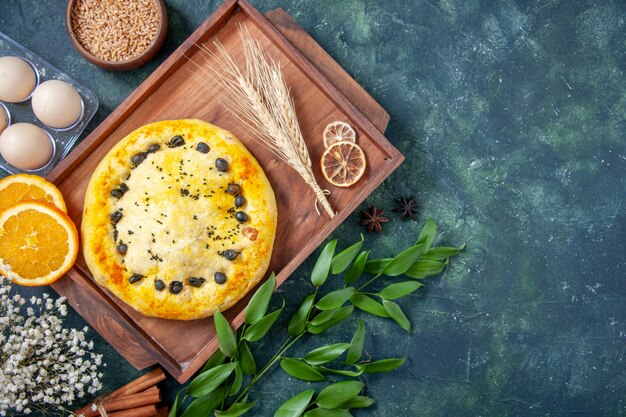 Top view sweet pie with eggs on dark-blue background hotcake dessert fruit bake cake cookie pastry bake pie