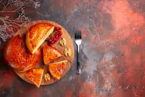 Free photo top view of sweet pies with cup of tea