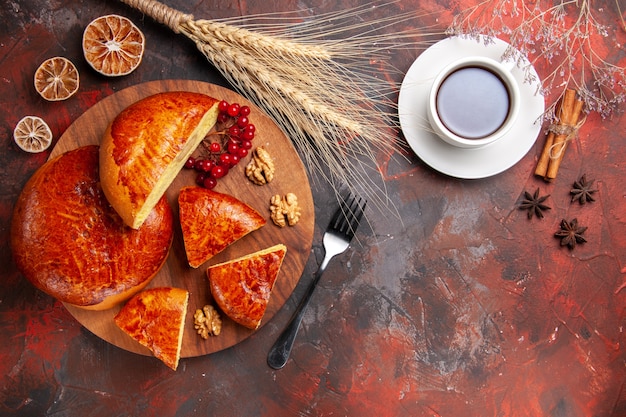 Top view of sweet pies with cup of tea