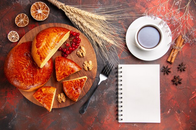 Top view of sweet pies with cup of tea