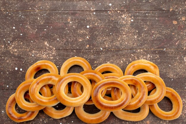 top view sweet round crackers dried and tasty snacks on brown, cookie biscuit drink