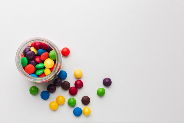 Top view sweets in a glass on white table