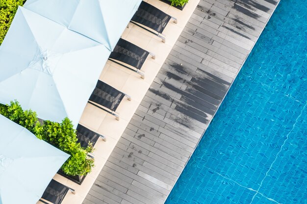 Top view of swimming pool with deck chairs