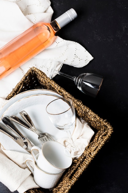 Top view tableware next to bottle of wine