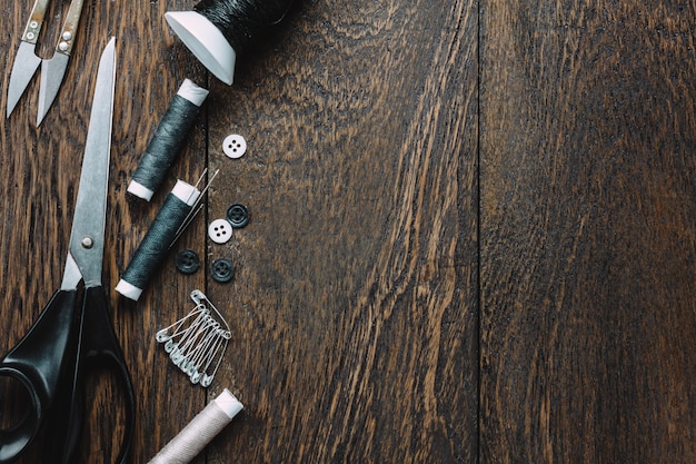 Top view tailor items on wooden background with copy space.