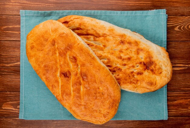 Top view of tandir breads on blue cloth and wooden table