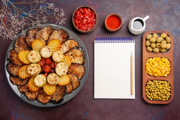 Top view tasty baked vegetables potatoes and eggplants on dark background meal oven cooking bake vegetable