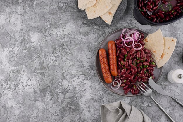 Top view tasty beans dish with sausages