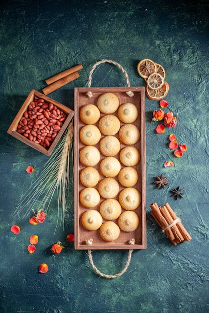 Top view tasty biscuits with peanuts on a dark background sugar cookie biscuit pie nut tea cake color sweet