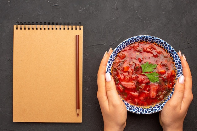 Top view tasty borsch famous ukranian beet soup on a dark space