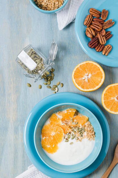 Top view tasty breakfast bowl with orange