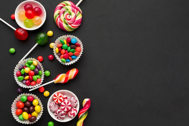 Top view tasty candies on black table