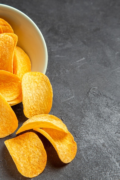 Top view tasty cheese chips inside plate on dark background