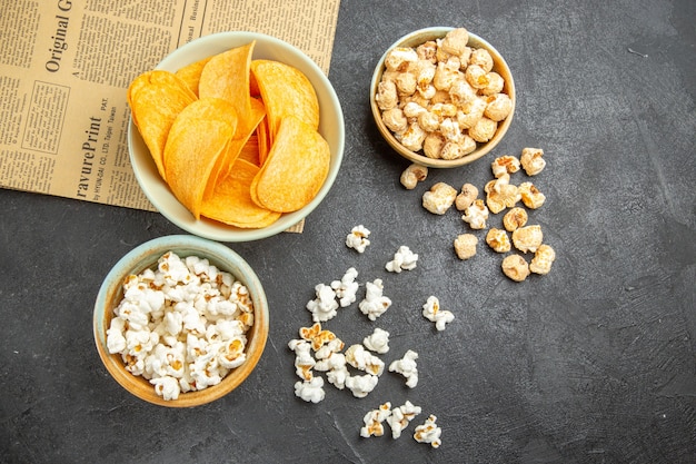 Free photo top view tasty cheese chips with different snacks on dark background