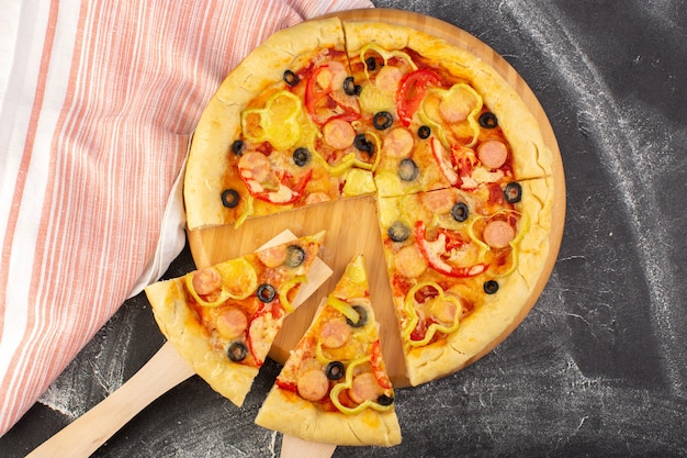 Top view tasty cheesy pizza with red tomatoes black olives bell-peppers and sausages on the grey background fast-food italian dough meal food bake