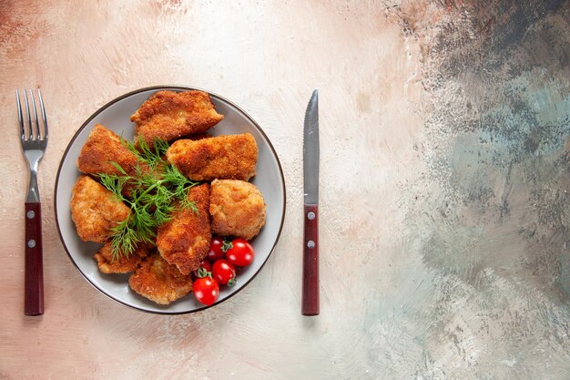 Top view tasty chicken wings with greens and tomatoes on light background food sandwich meat lunch burger meal