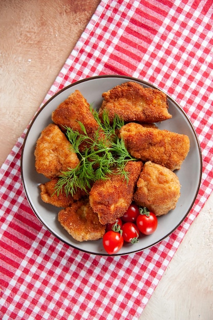 Top view tasty chicken wings with greens and tomatoes on light background fries burger food meal lunch meat dinner