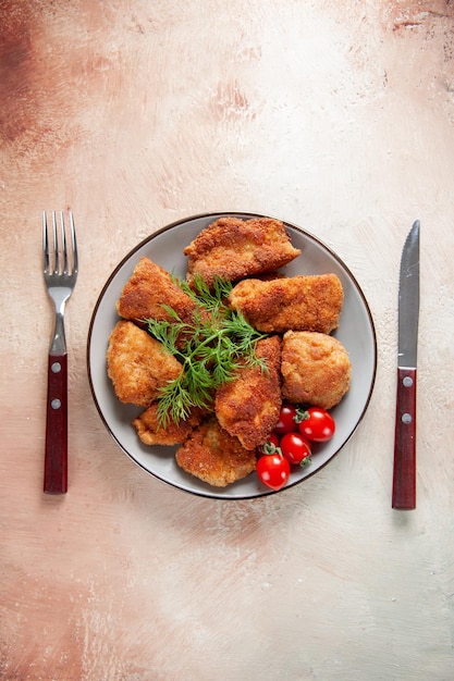 Top view tasty chicken wings with greens and tomatoes on light background fries food sandwich meat burger meal