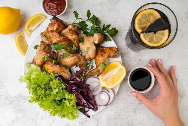 Free photo top view tasty chicken wings with salad