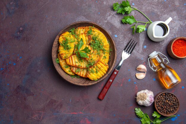 Top view tasty cooked potatoes with greens on dark surface potato dinner dish cips cooking meal