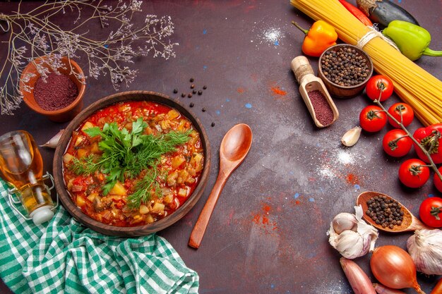 Top view tasty cooked vegetables sauce meal with different seasonings and tomatoes on dark background sauce meal dish food